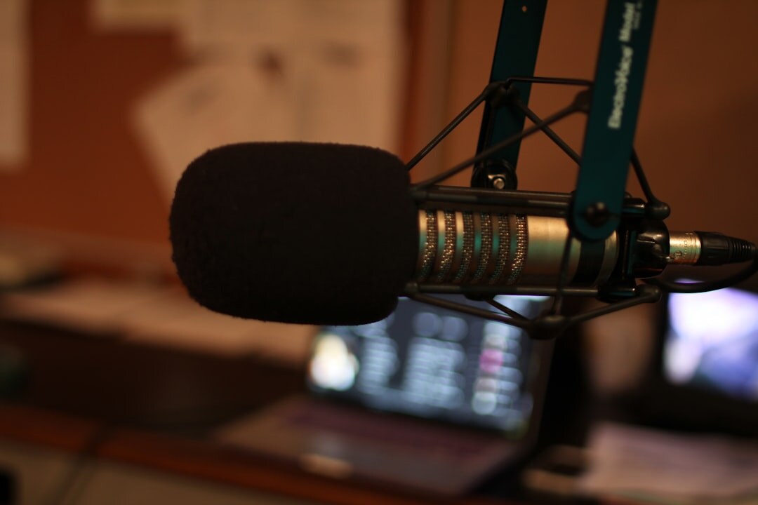 Audio mixing console with faders and knobs in a podcast studio