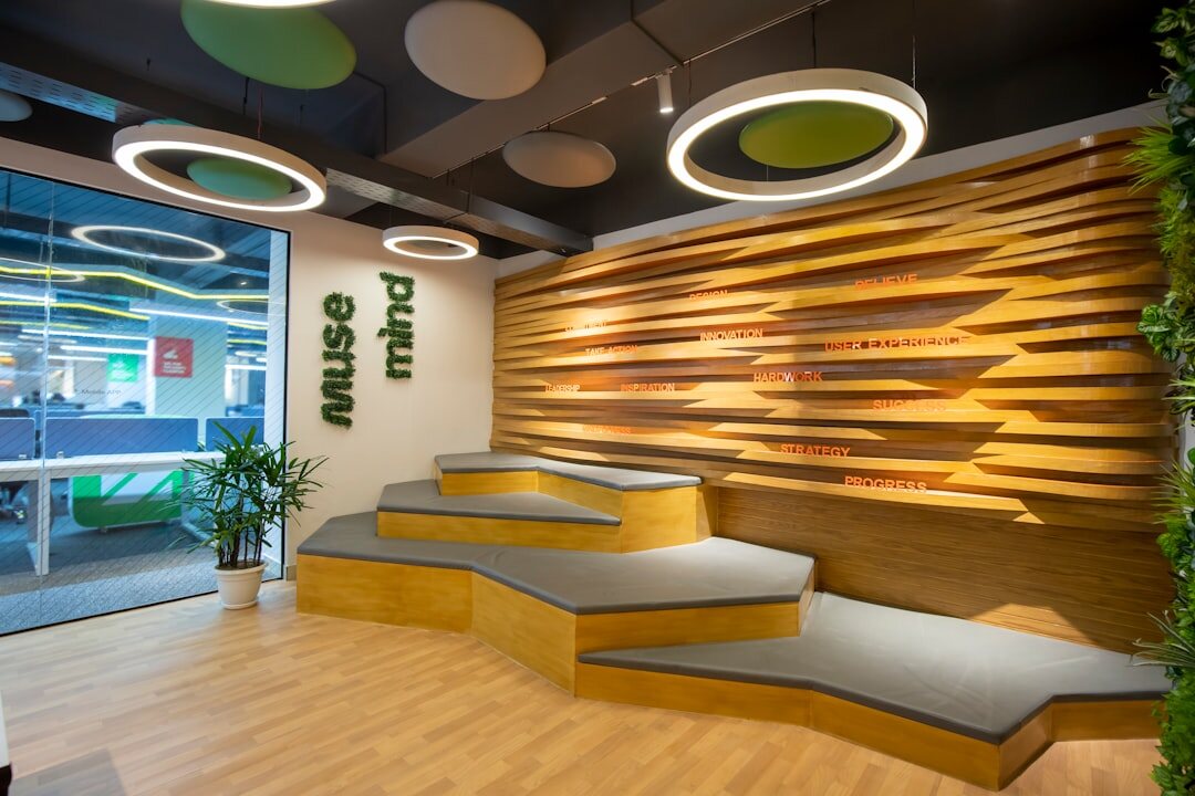Bright reception area of a media studio office with plants and seating