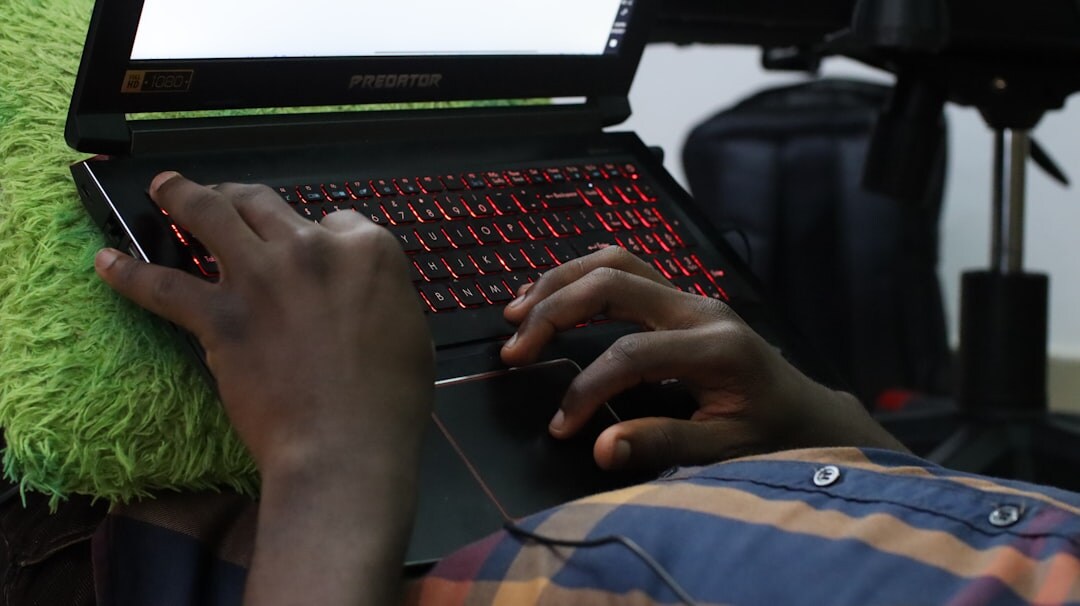 person editing audio on laptop