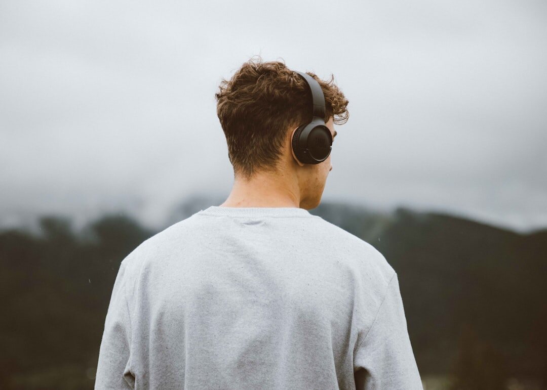 person listening to podcast on headphones