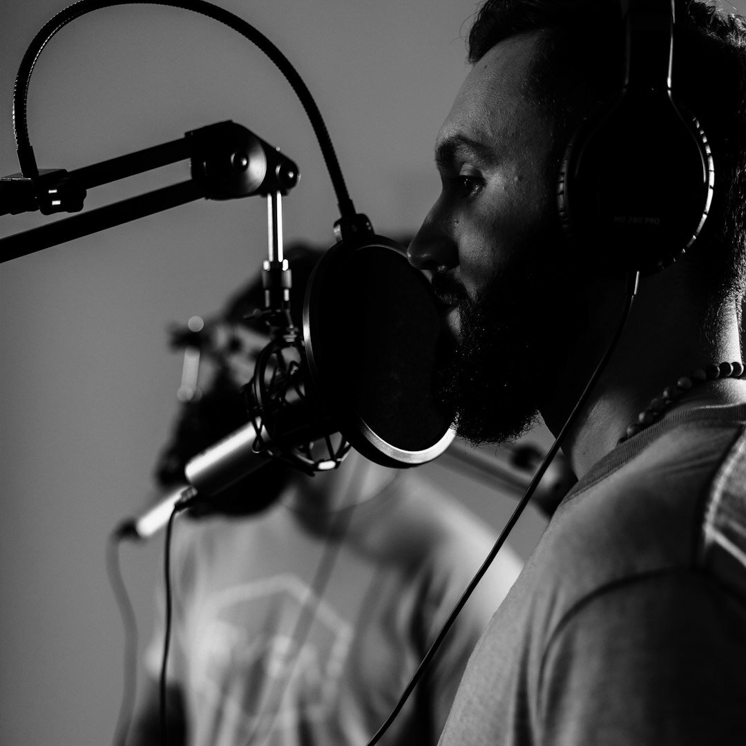 Professional condenser microphone on a boom arm in a podcast studio